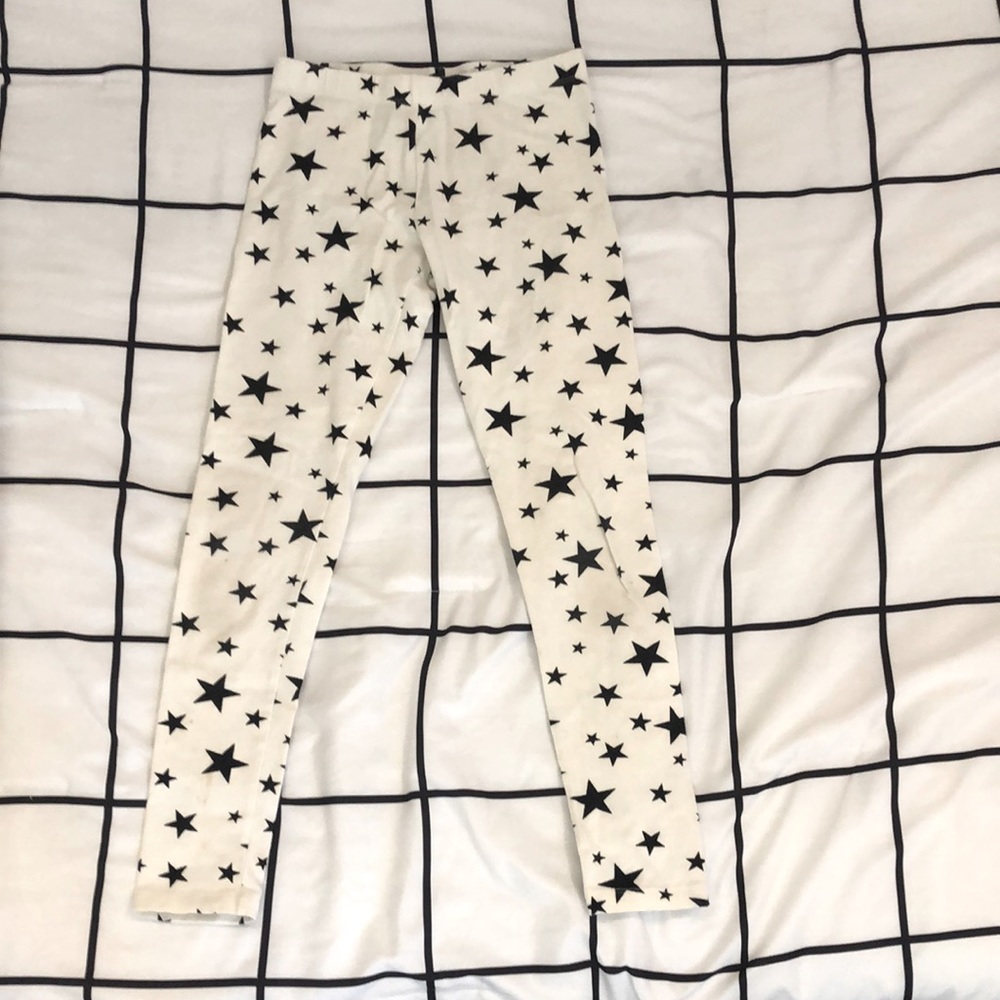 This is a kids pants which are a size Large and are white with black stars